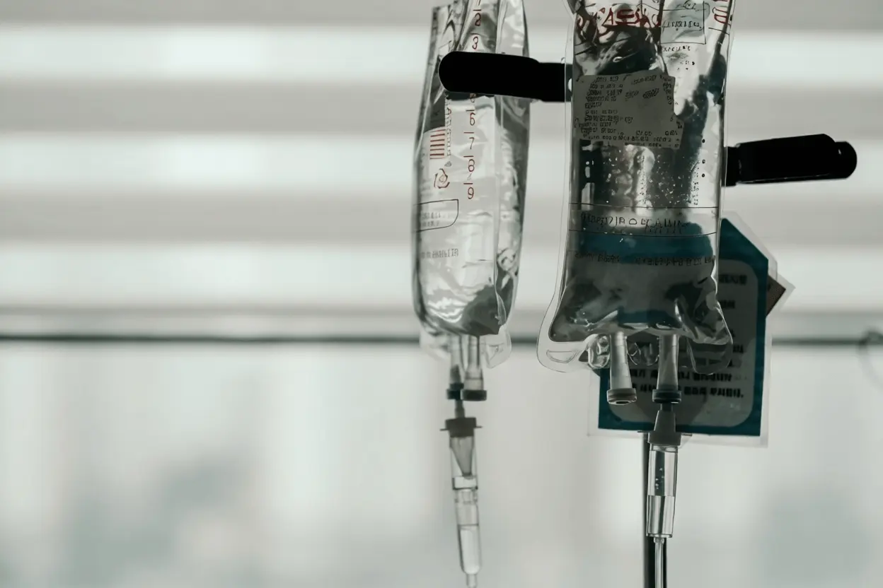 IV fluid bags hanging, ready for therapy.